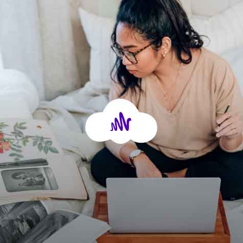 A woman on her laptop with a cloud icon on top of the image