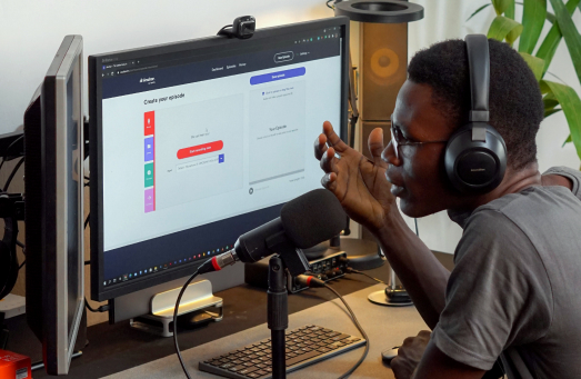 Photo of a person recording a podcast