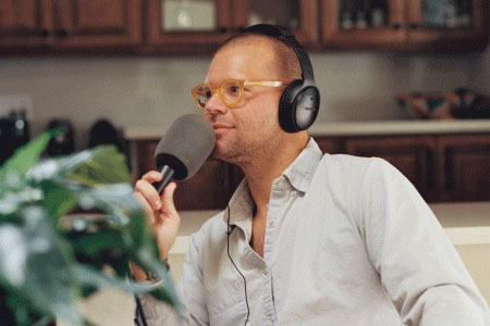Photo of Chris Black recording the How Long Gone podcast