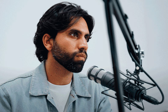 Photo of Samir recording The Colin and Samir podcast