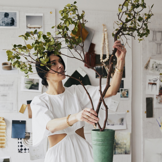 Athena Calderone from the More Than One Thing podcast tending to her plants at home