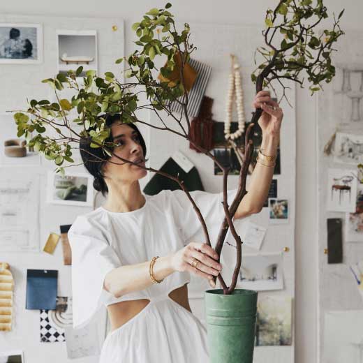Athena Calderone from the More Than One Thing podcast tending to her plants at home