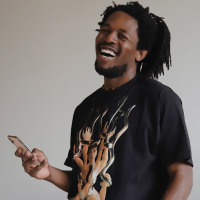 Man laughing while listening to podcast on his iPhone