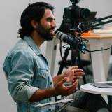 Man recording a new track for into a microphone for a podcast